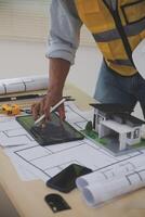 Image of engineer meeting for architectural project. working with partner and engineering tools on workplace vintage tone. photo