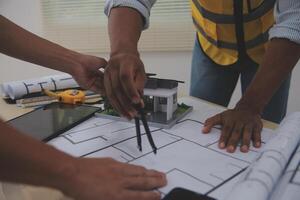 Image of engineer meeting for architectural project. working with partner and engineering tools on workplace vintage tone. photo