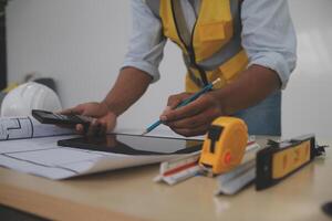 Image of engineer meeting for architectural project. working with partner and engineering tools on workplace vintage tone. photo