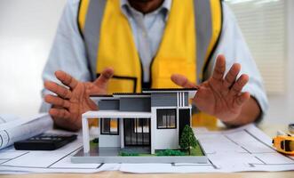 Architects, engineers, contractors working in the office with blueprints, inspection engineers Work analysis for architectural plan, construction project sketch, focus, business construction concept. photo