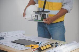 Image of engineer meeting for architectural project. working with partner and engineering tools on workplace vintage tone. photo
