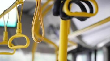 A row of yellow handle on a bus video