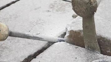 A group of workers using a jackhammer to break and remove concrete sections on a construction site video