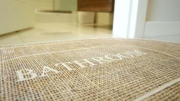 A bathroom mat placed on a clean tiled floor, creating a welcoming and cozy environment in the room video