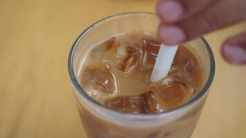 Enjoy a Refreshing Iced Coffee, complete with Ice Cubes in a Clear Glass for your delight video