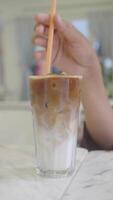 Enjoy a Refreshing Iced Coffee with Creamy Swirls and Ice Cubes for a perfect treat video