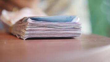 A Stack of Currency Notes Neatly Arranged on a Wooden Table, Representing Wealth video