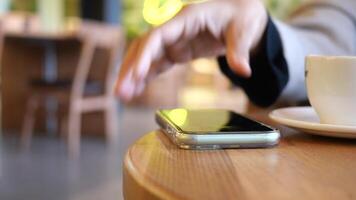 man hand picking up smart phone mobile to receive a call video
