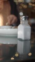 Close-Up Shot of a Salt Shaker on a Reflected Dining Table Surface video