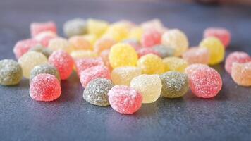 Bright and Colorful Assorted Fruit Gummies Displayed on a Dark Surface video