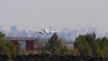 Unrecognizable plane landing, touching down and braking. Haze creates poor visibility video