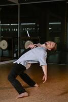 A man performs a randomized movement for yoga at a fitness gym photo