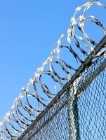 Barbed wire fence for security prison imprisonment safety and protective photo