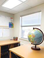 Globe in a school classroom learning geography map on a desk photo