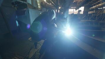 A Welder Engaged in Their Craft in an Industrial Setting with a Bright Welding Arc Visible. Stock Clip video
