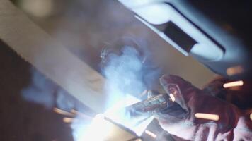 A Skilled Welder is in Action, Creating with Beautiful Sparks and Smoke Effects During the Job. Stock Clip video