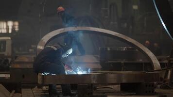 A Skilled Welder Engaged in the Process of Working on Industrial Equipment within a Factory Setting. Stock Clip video