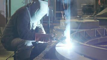 A Skilled Expert Welder at Work in a Busy Industrial Setting Focusing on High Quality Craftsmanship. Stock Clip video