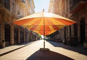 Multicolored umbrella on street between the urban buildings. photo