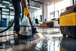 A worker cleaning floor with washing machine. photo