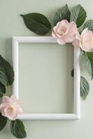 Floral Frame with Pastel Pink Flowers and Green Leaves on Light Green Background. photo