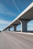 Large concrete overpass stretching into the distance under a clear sky. photo