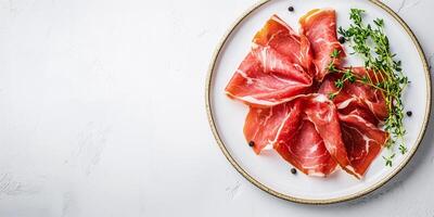 Prosciutto slices displayed on a white plate, with a sprig of fresh herbs, food photography photo