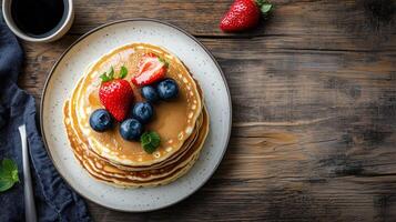 Breakfast table setting with a stack of buttermilk pancakes on one plate, gastronomy photography photo