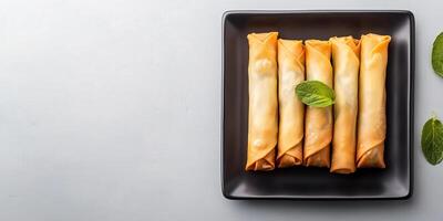 Spring rolls arranged evenly in a row on a rectangular plate, gastronomy photography photo