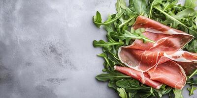 Prosciutto slices draped over a small pile of arugula leaves, gastronomy photography photo