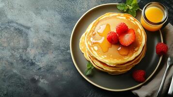 Breakfast table setting with a stack of buttermilk pancakes on one plate, food setting photo