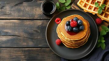 Dining table with stack of pancakes near serving of waffles, meal photography photo