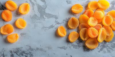 Few dried apricots scattered on a flat surface, meal photography photo