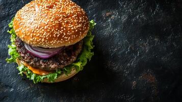 Grilled beef burger with lettuce, onions, and cheese on a sesame bun, food setting photo