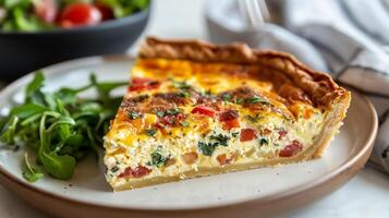 Close-up view of quiche slice on a plate, visible filling layers, and small salad bowl, food setting photo