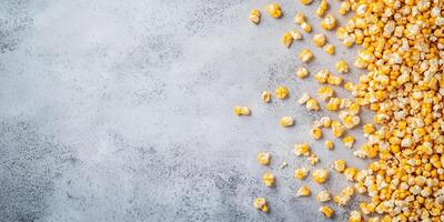 Kettle corn scattered on a flat surface, with popped kernels clearly visible, food setting photo