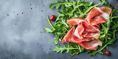 Prosciutto slices draped over a small pile of arugula leaves, food setting photo