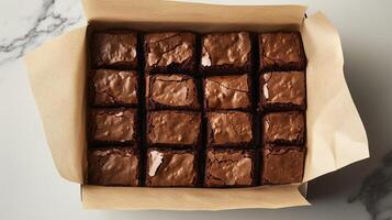 Paper-lined box filled with uniformly cut brownies, arranged in a single layer, gastronomy photography photo