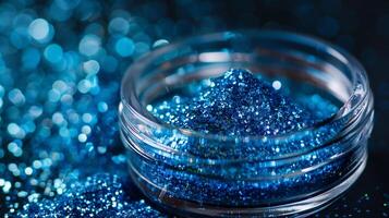 Close-up of glass container with blue edible glitter on smooth surface, meal photography photo