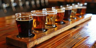 Flight of ale samples in small glasses, lined up on a wooden board, meal photography photo