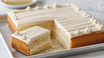 Partially sliced sheet cake, showing even portions, on a simple white tray, food setting photo