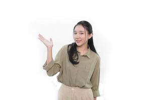 The smiling expression of an Indonesian Asian woman in green and raising one hand to the side photo