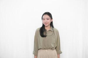 The smiling expression of an Indonesian Asian woman in green is standing ready photo