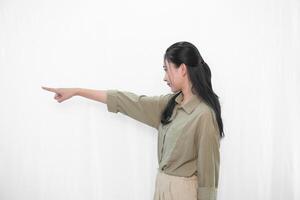 The expression of a smiling and pointing forward Indonesian Asian woman in green clothes from photo