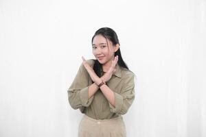 The smiling expression of an Indonesian Asian woman in green and making a symbol of disagreement photo