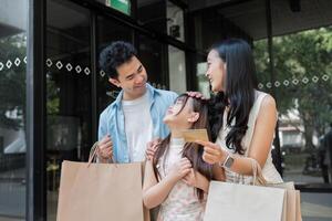 Happy Family Enjoying a Day of Shopping Together with Smiles and Laughter in a Modern Urban Setting photo