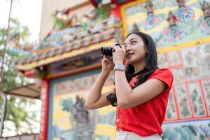 Celebrating chinese new year a photographer captures joyful moments in colorful environment with camera in community festivities photo