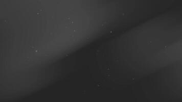 Dark gray background features subtle diagonal light streaks dust motes. video