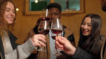 Friends celebrate with drinks and laughter during a cozy gathering in an inviting atmosphere on a chilly evening video