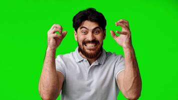 Man showing intense emotion with facial expressions and body language against a green background video